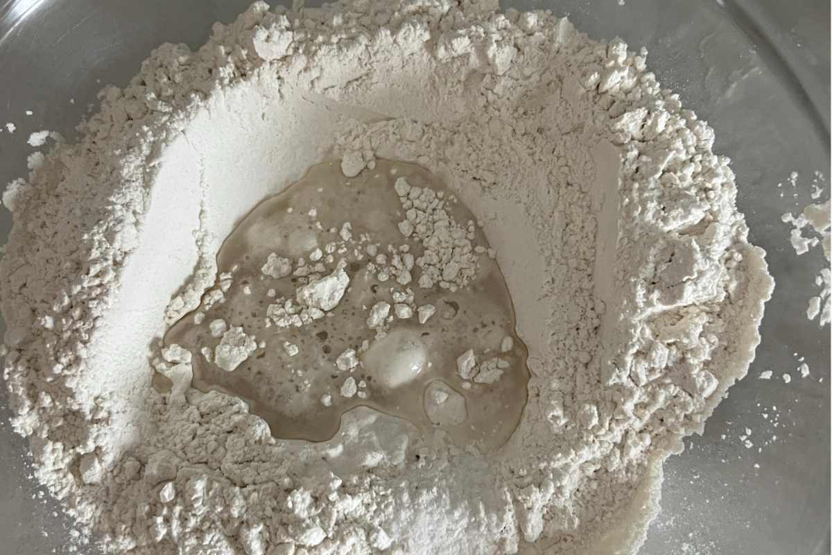 Flour and dough mixed together in a bowl.