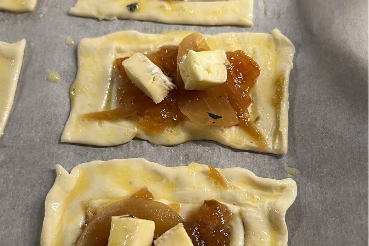 Puff pastry bites filled with fig jam, onions, and brie.