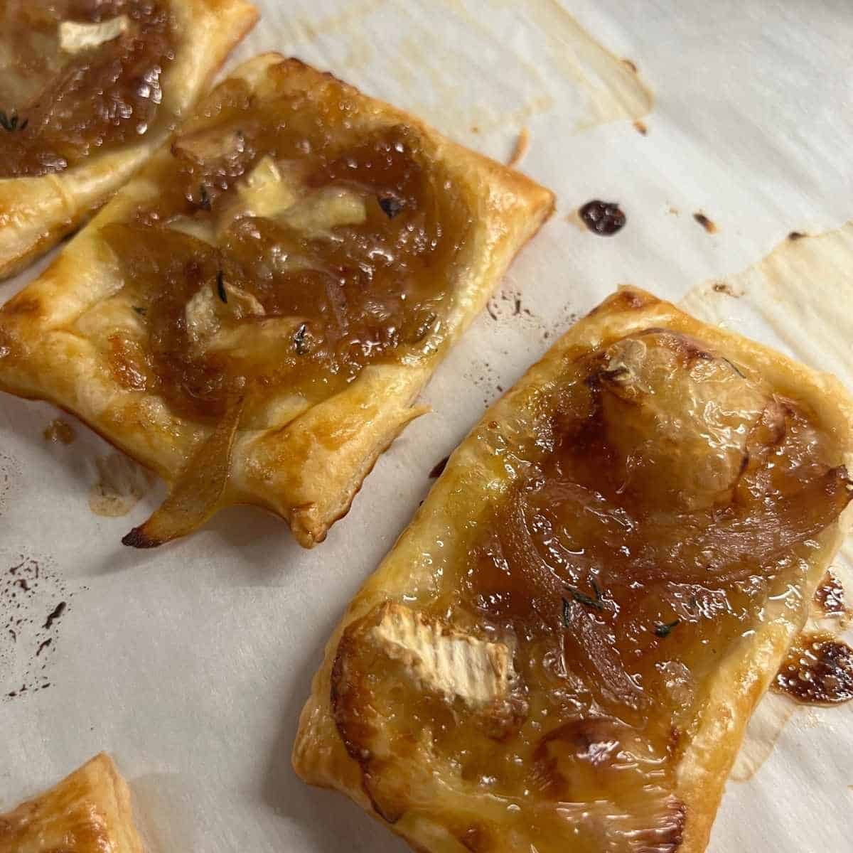 Finished puff pastry tarts on a sheet pan.