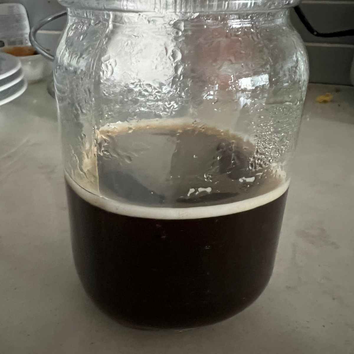 Brewed coffee in a glass jar. 