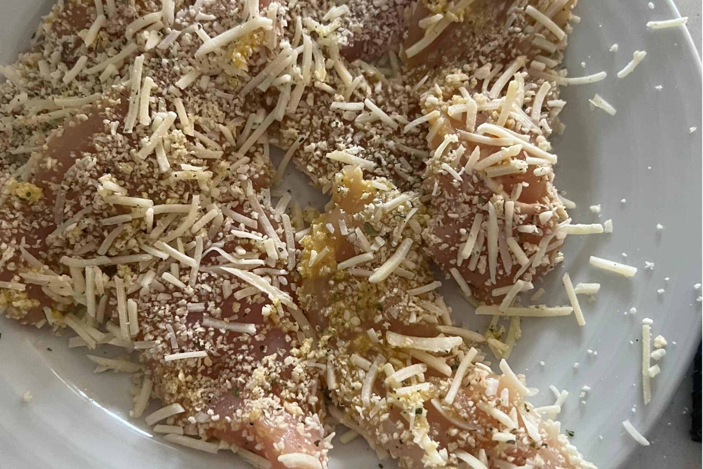 Chicken dipped in egg wash and brumb crumbs with cheese. 