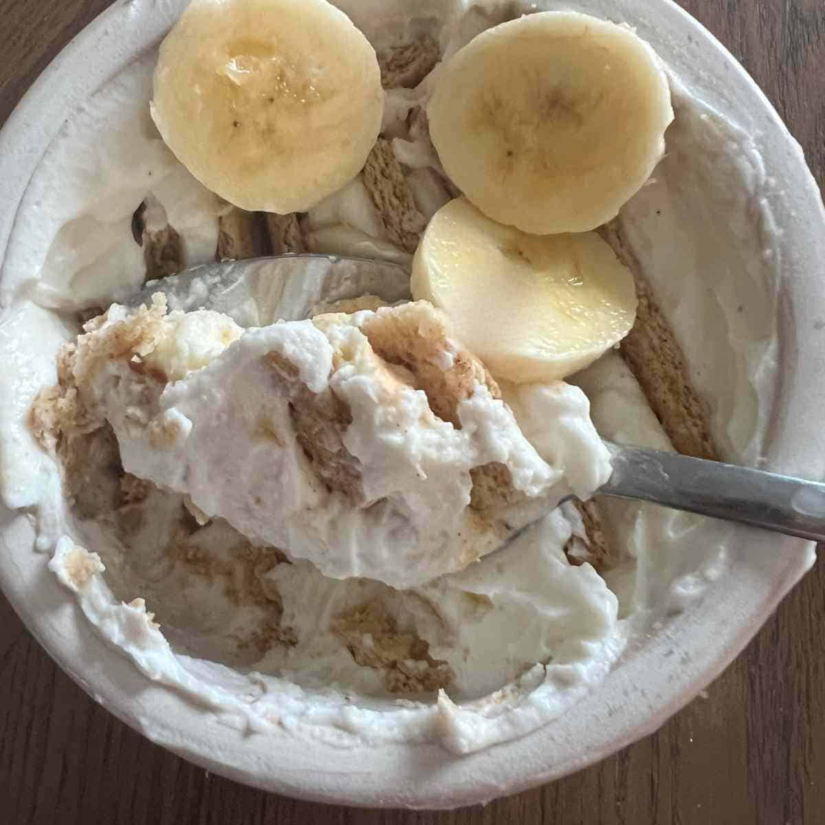 Yogurt spread a cup with cookies inserted into it.