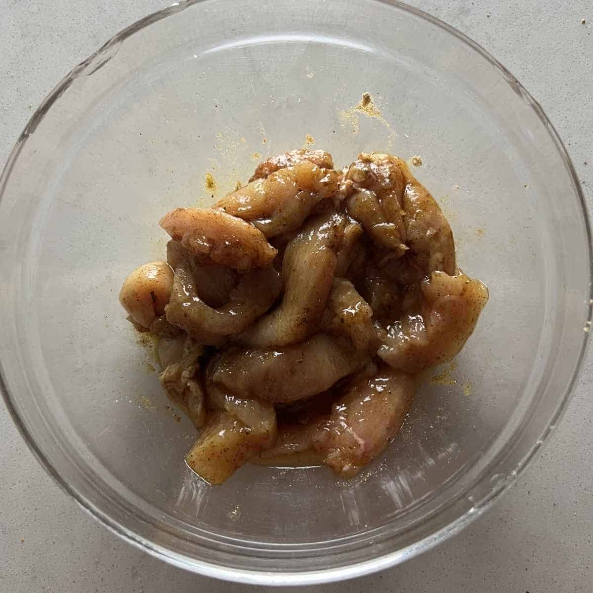 Seasoned chicken with fajita seasoning in a bowl. 