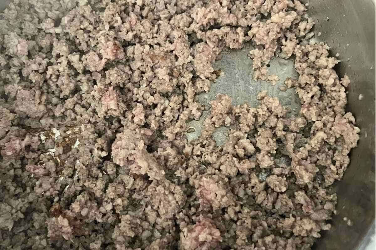 Pork sausage cooking in a pan. 