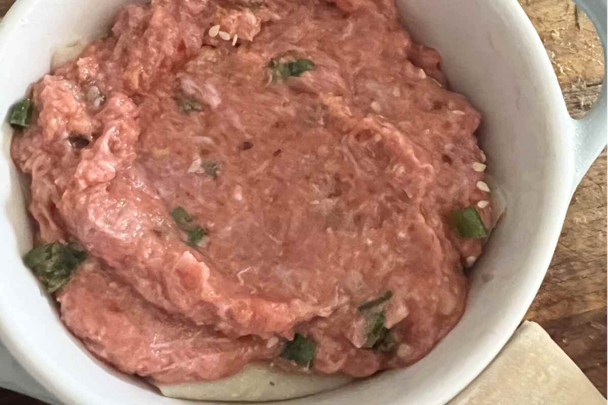 Dumpling mixture on top of layers. 