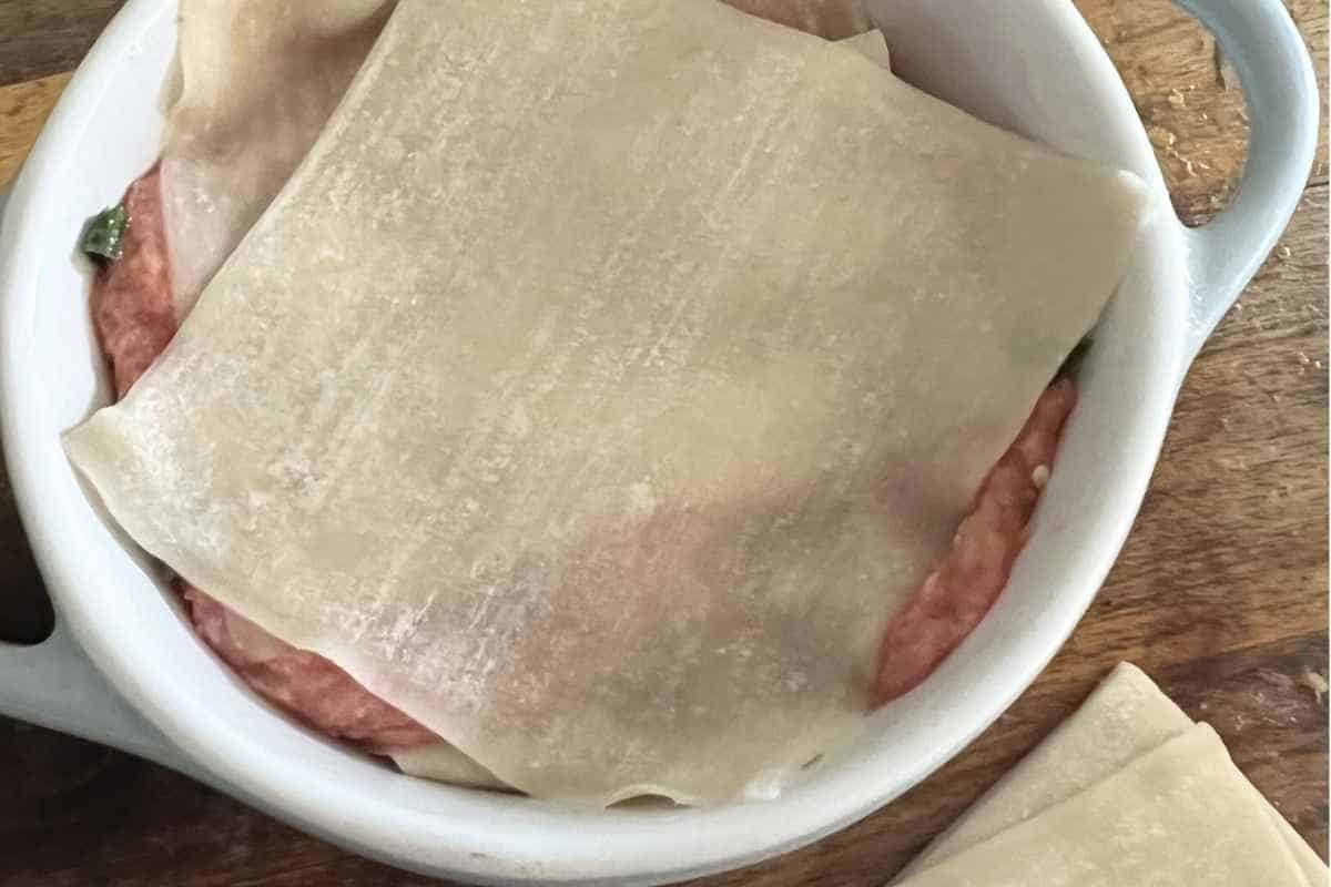 Layered dumpling lasagna with wonton wrappers. 