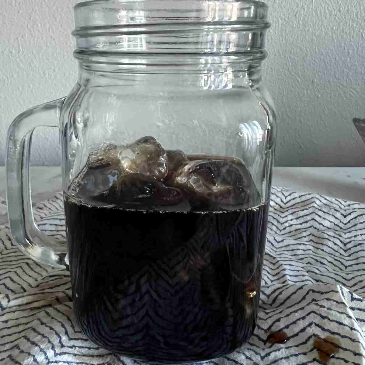 Brewed coffee in a glass with ice.