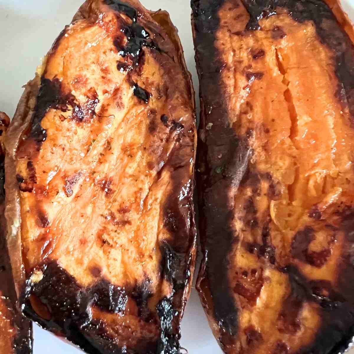 Carmelized sweet potatoes on a sheet pan.