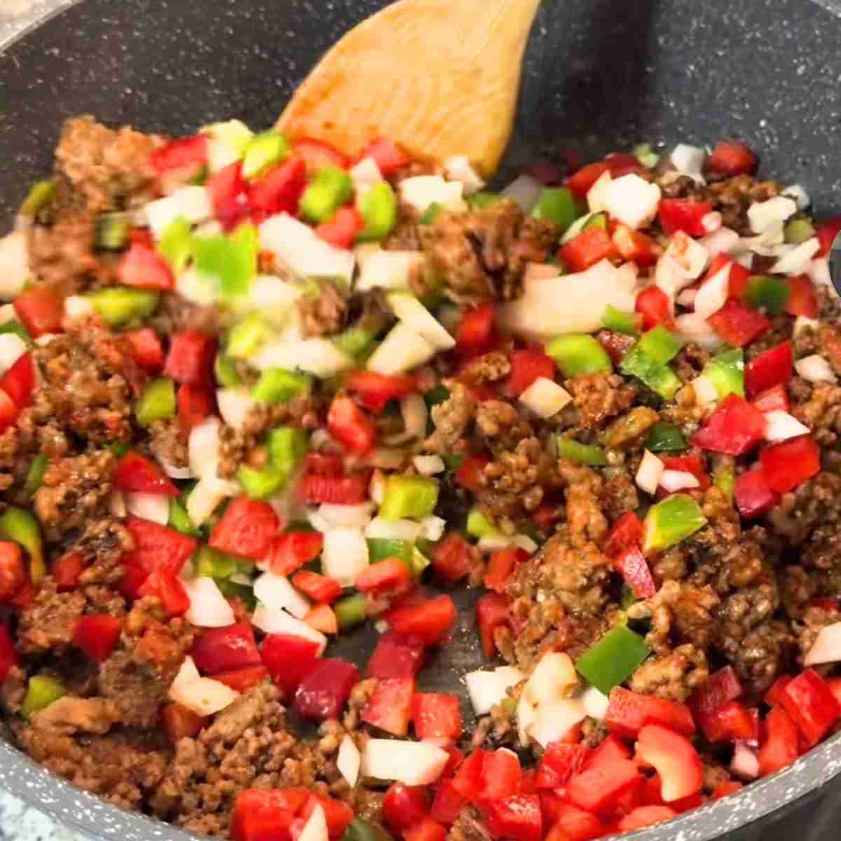 Protein and vegetables cooking in a pan.