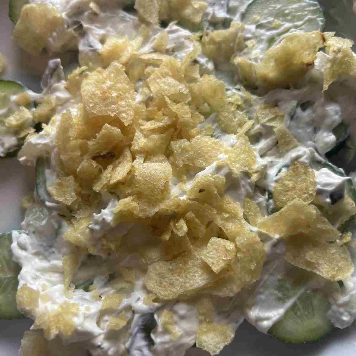 Crushed potatoes chips on top of cucumebrs.