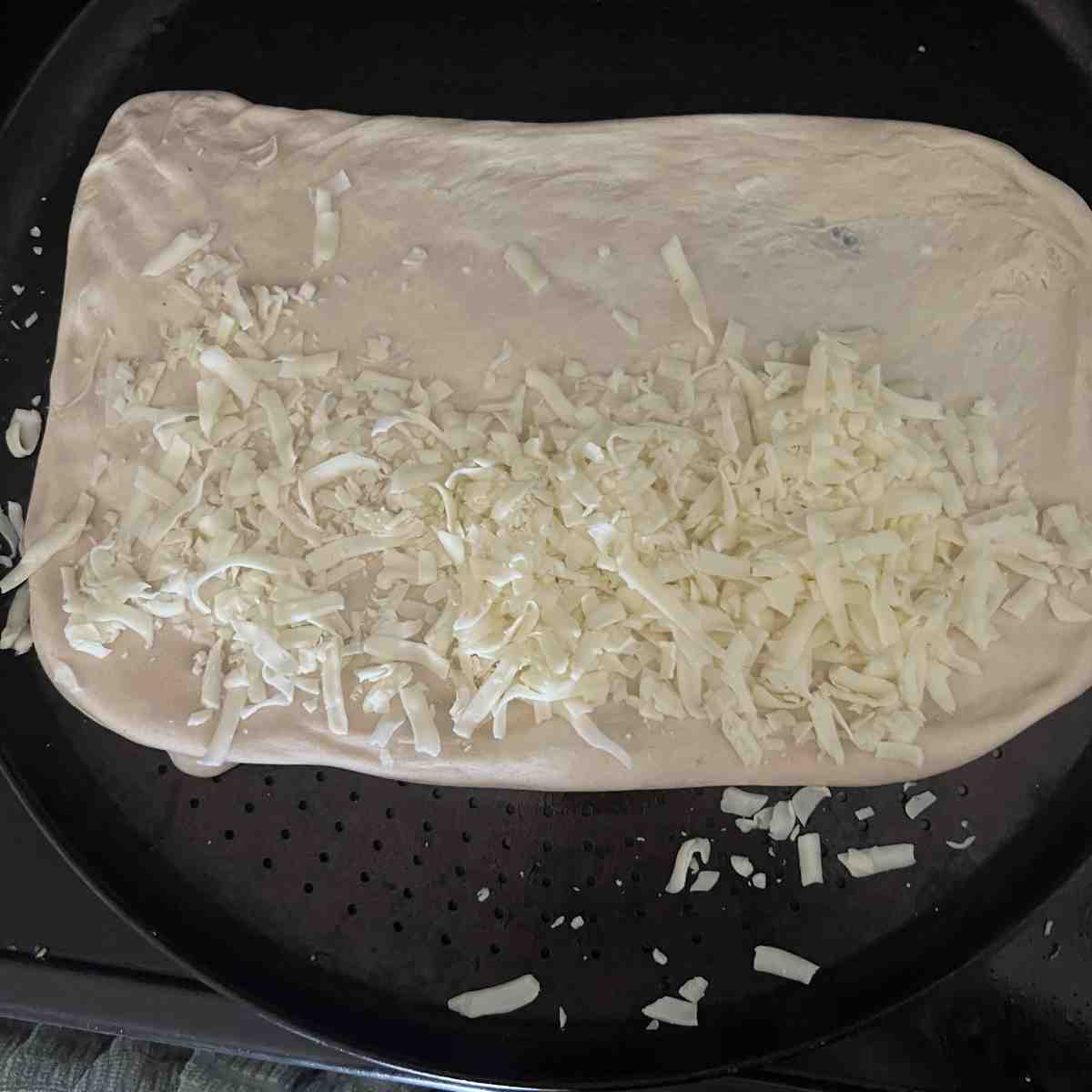 Mozzarella cheese on top of dough. 