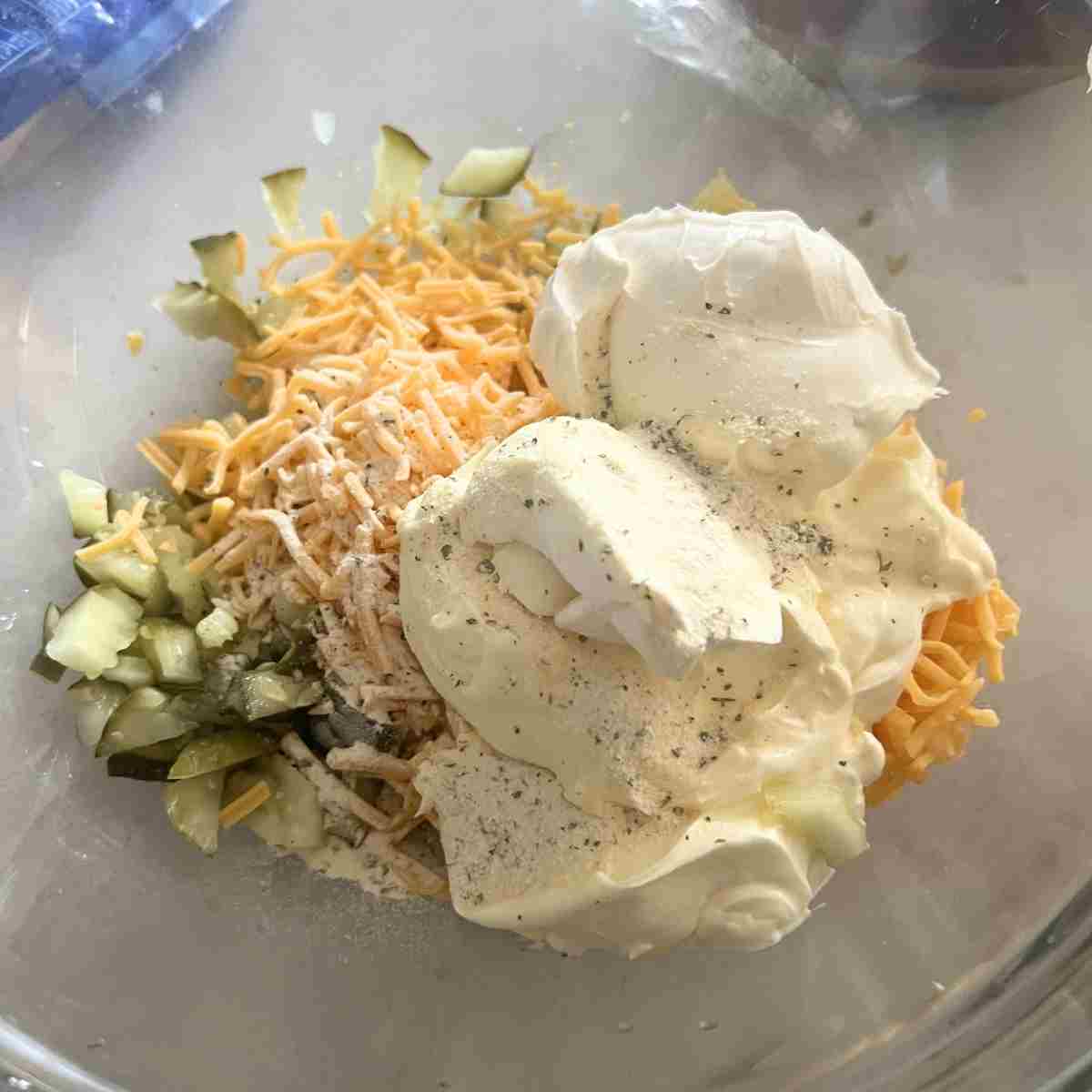 Ingredients for pickle dip in a bowl. 