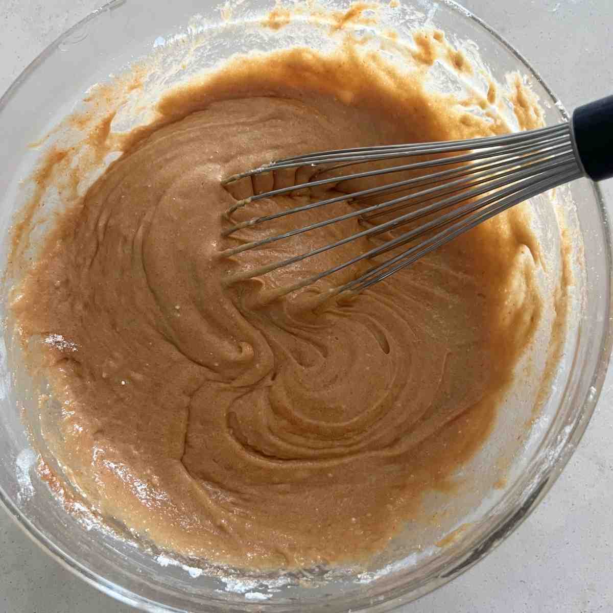 Cake mix ingredients combined in a bowl. 