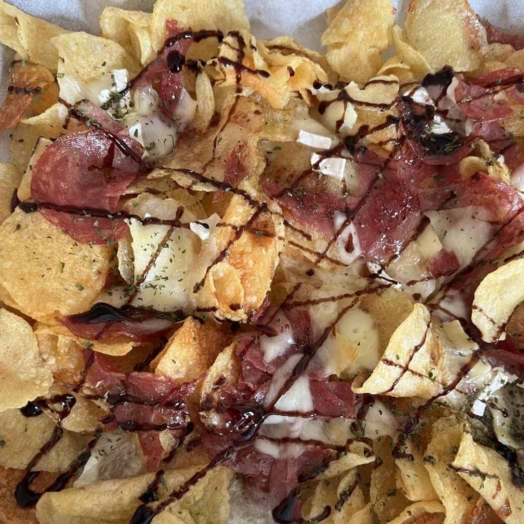 Finished charcurterie nachos drizzled with balsamic glaze. 