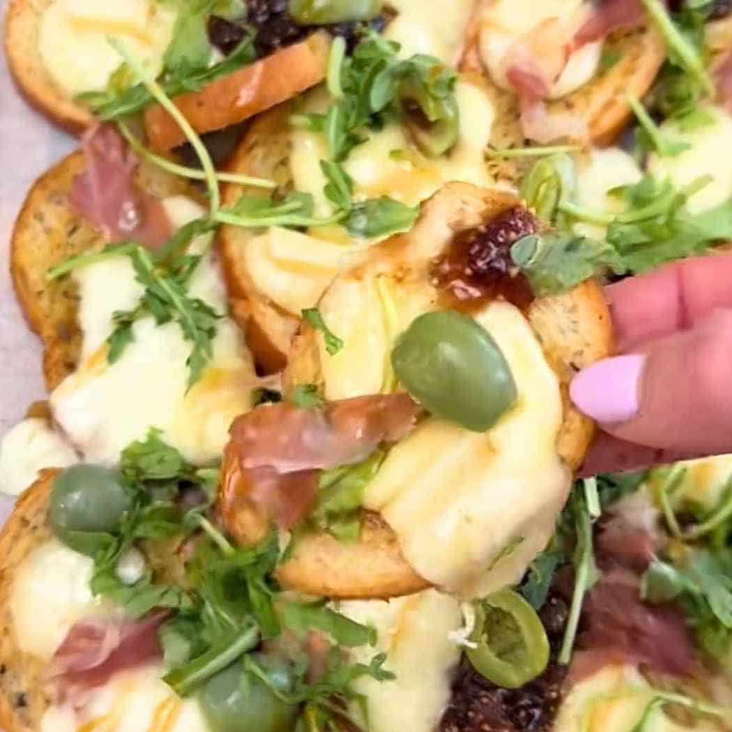 Charcuterie nachos made with bagel chips.