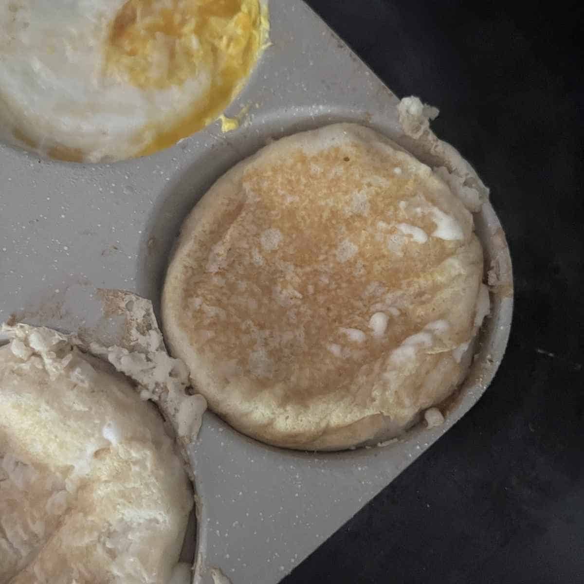 Finished eggs and pancake mix cooking in a 4 hole pan. 