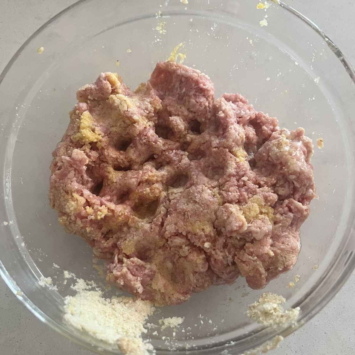 Smoked meatball mixture in a glass bowl.