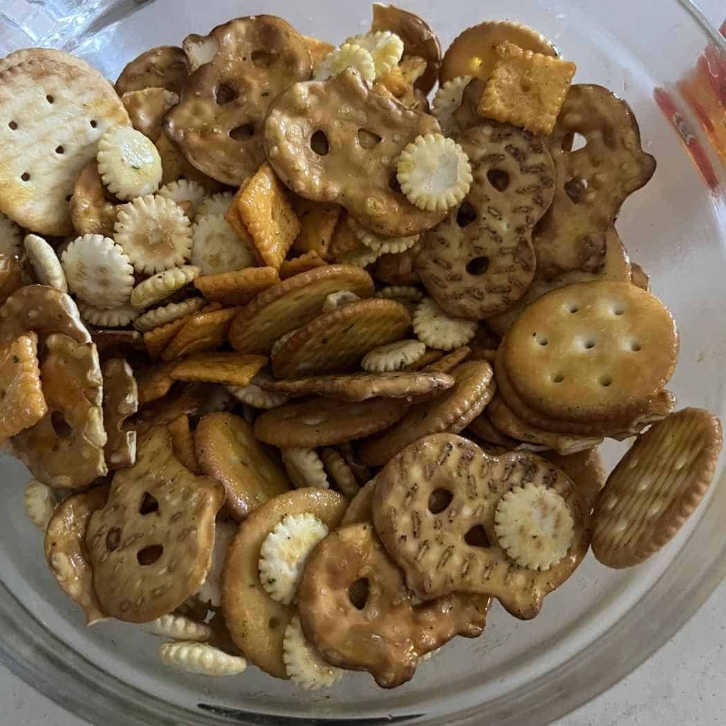 Crackers and seasoning combined in a bowl.