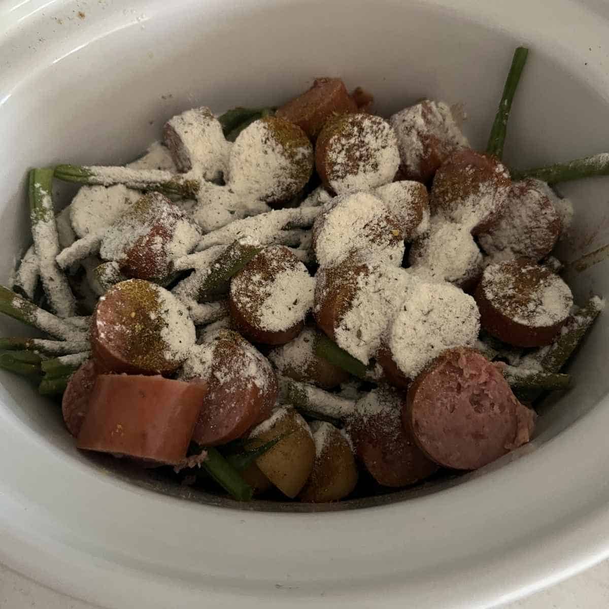 Sausage and potatoes with seasoning.