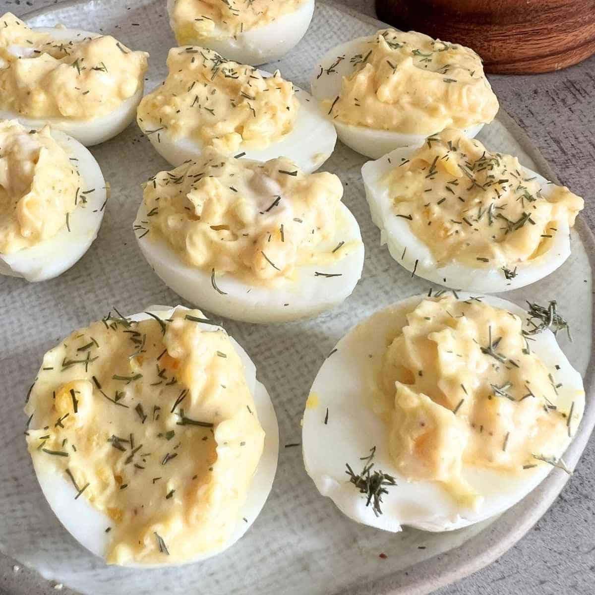 Deviled eggs sprinkled with dill seasoning.