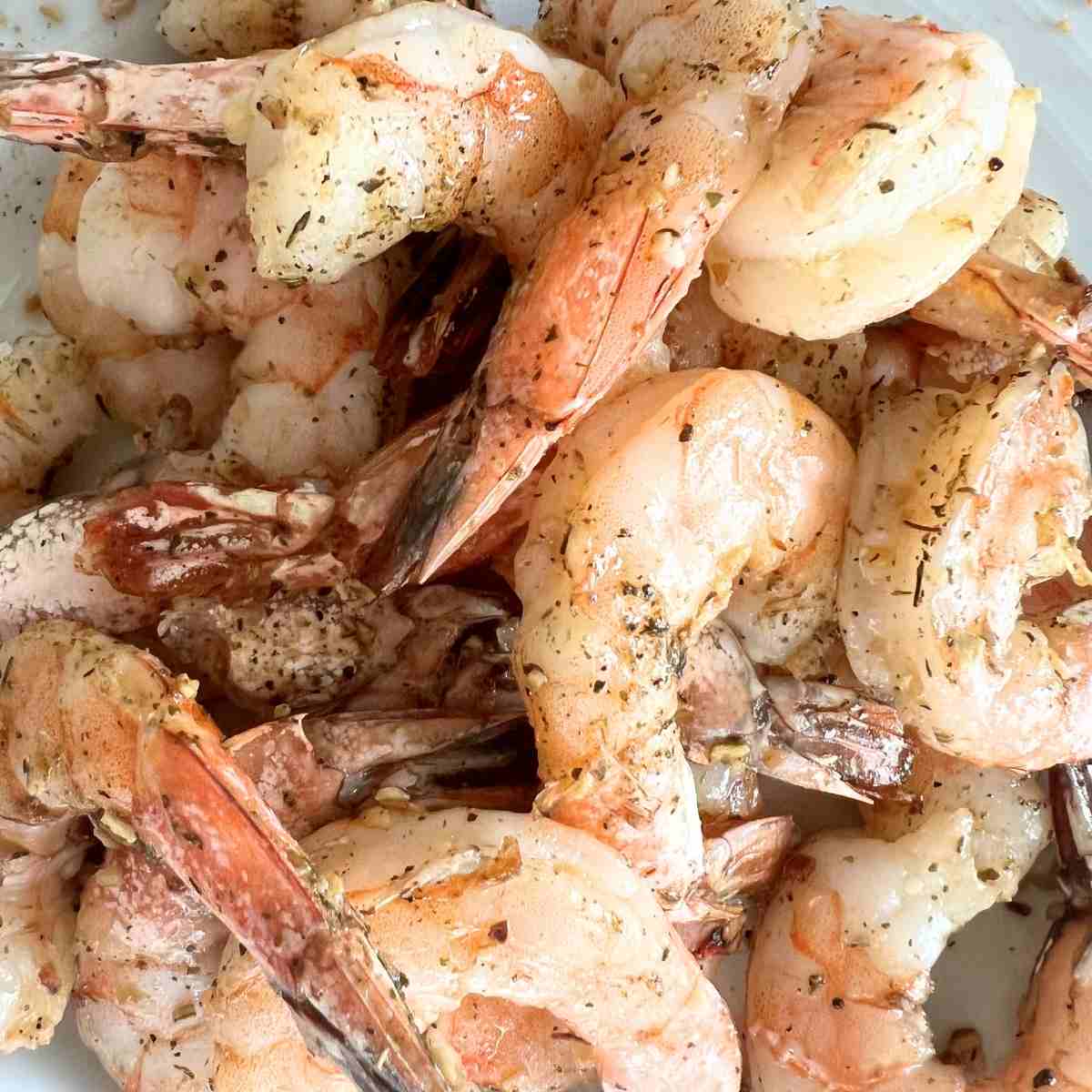 Cooked seasoned shrimp on a Blackstone griddle.