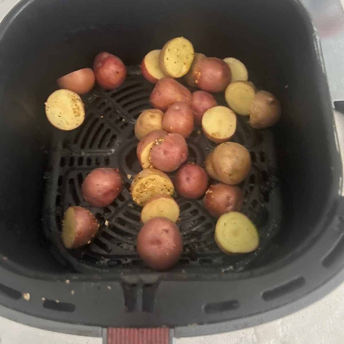 Baby potatoes in air fryer basket.