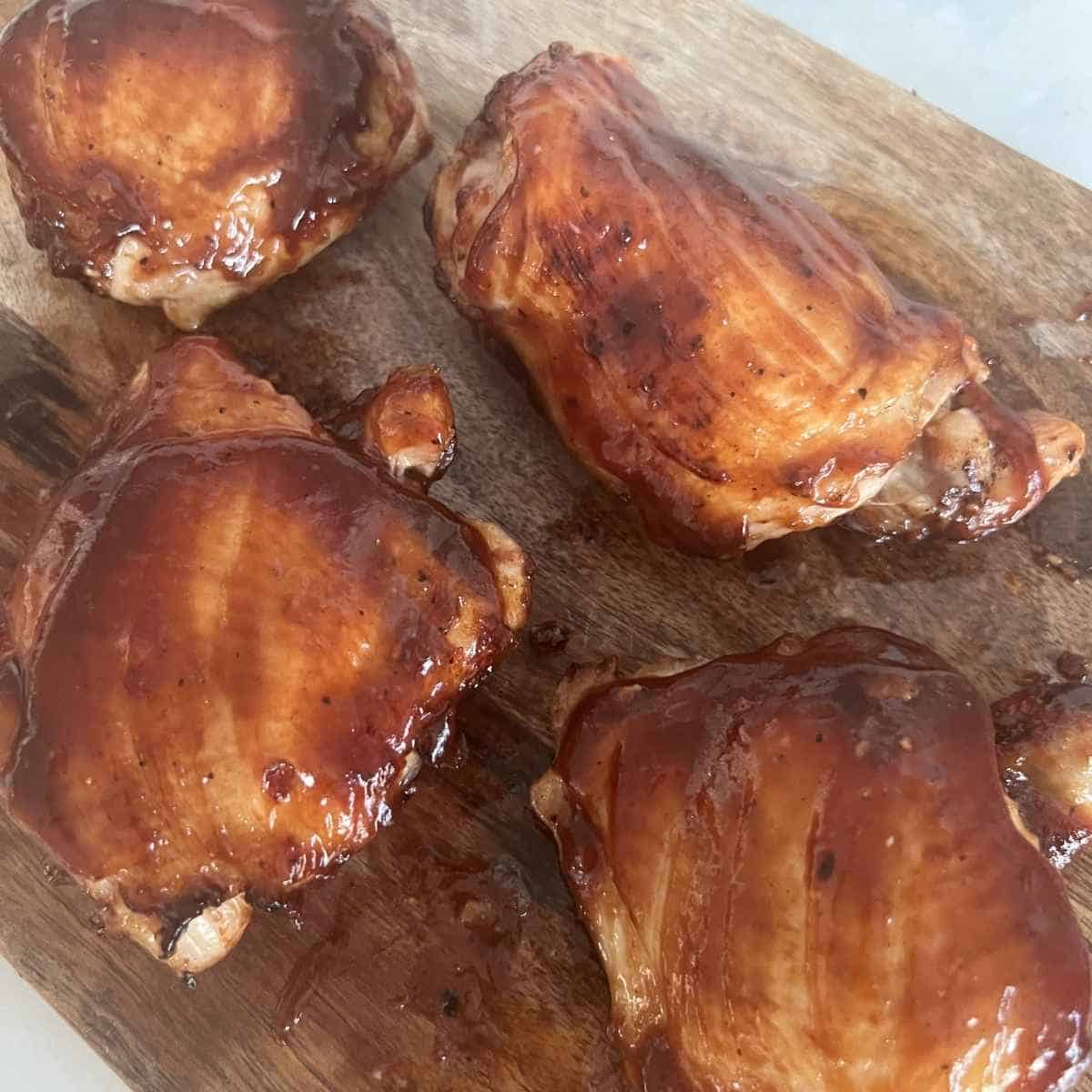Air fried BBQ chicken thighs brushed with BBQ sauce.
