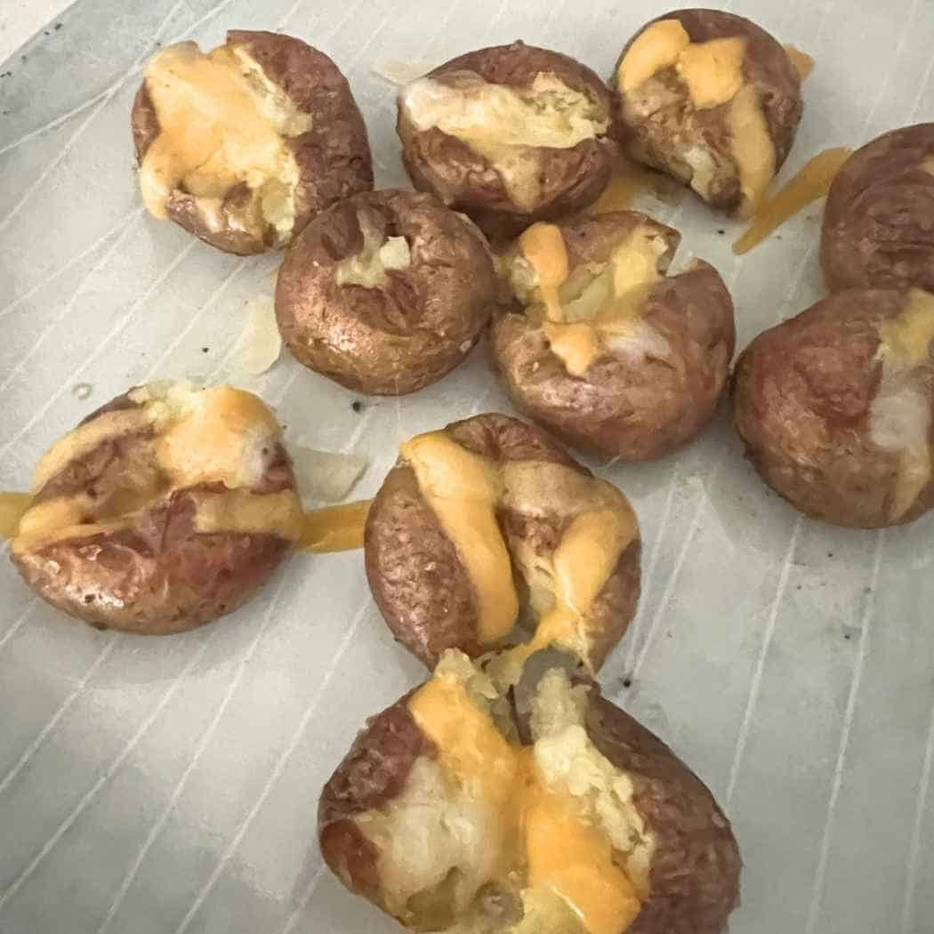 Melted cheese on baked potatoes. 