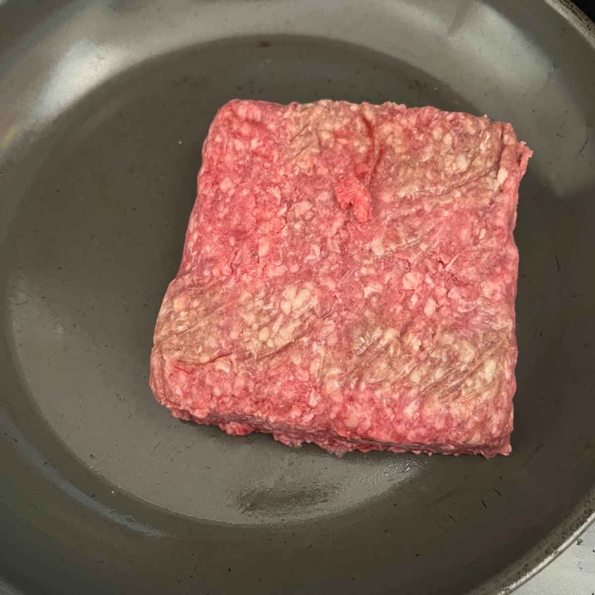 Ground beef in a skillet.