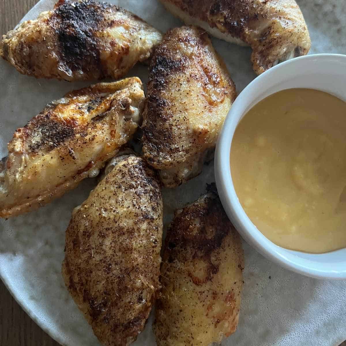 Air fryer frozen chicken wings with sauce.