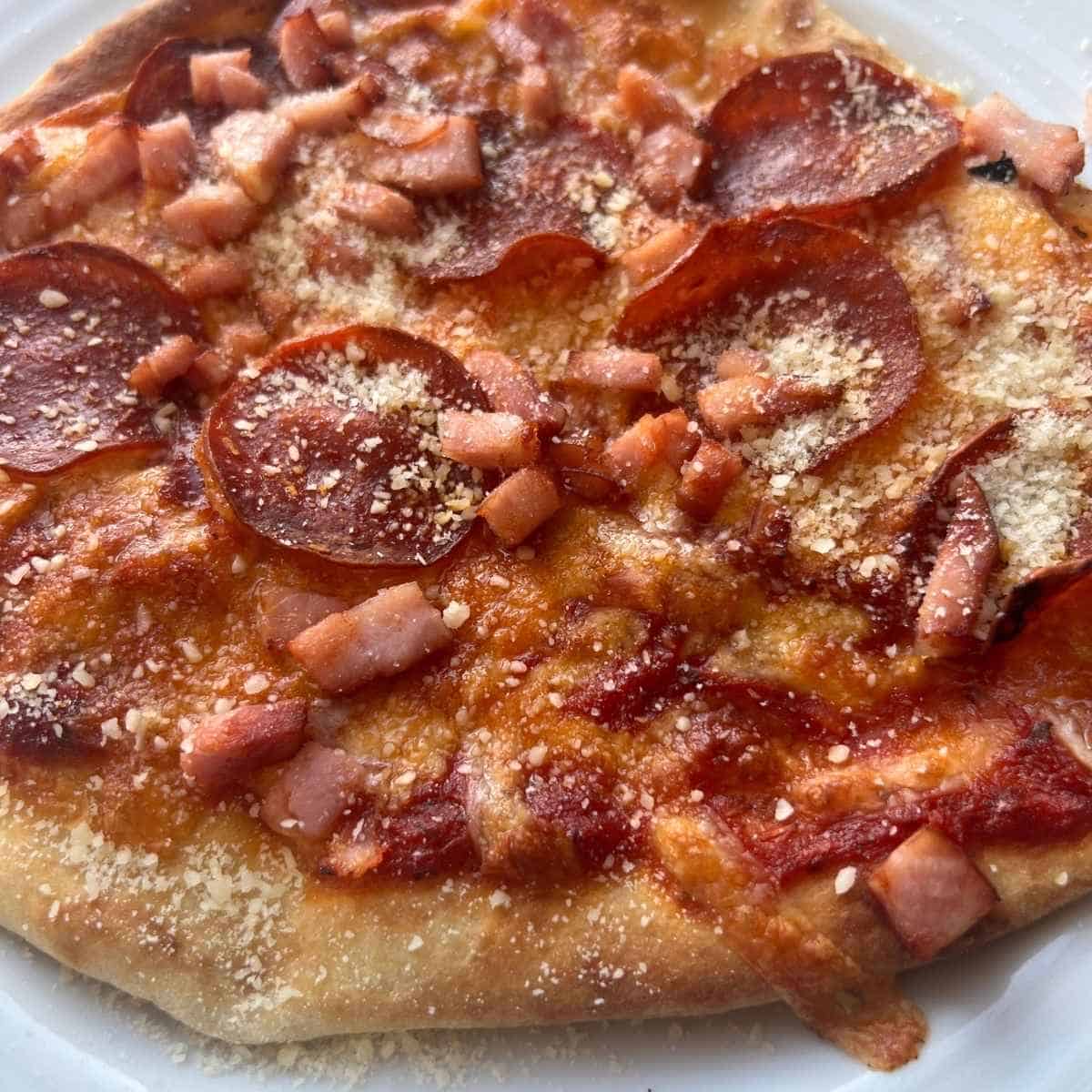 Air fryer naan pizza topped with parmesan cheese.