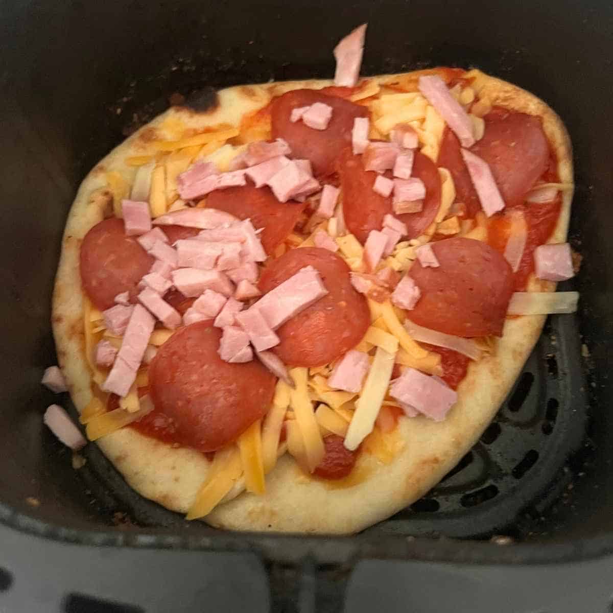 Toppings on naan bread.