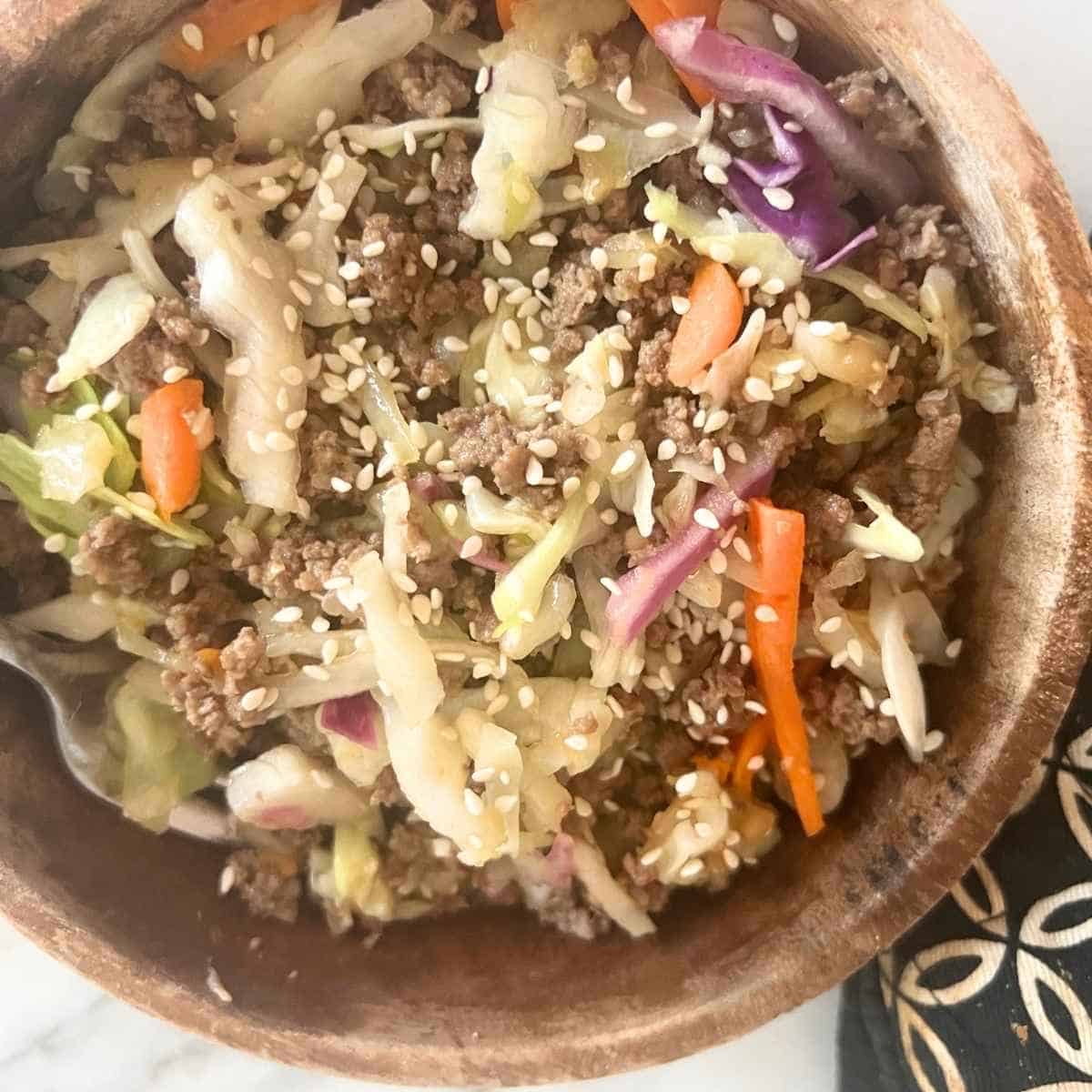 Beef egg roll in a bowl topped with sesame seeds.