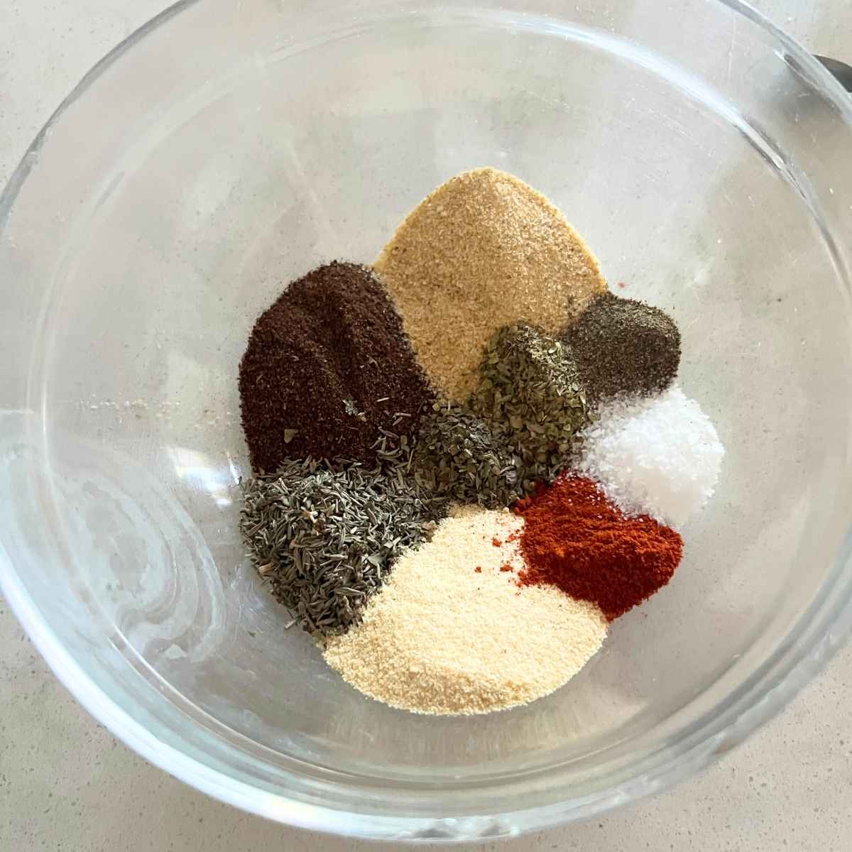 Seasoning ingredients in clear bowl.