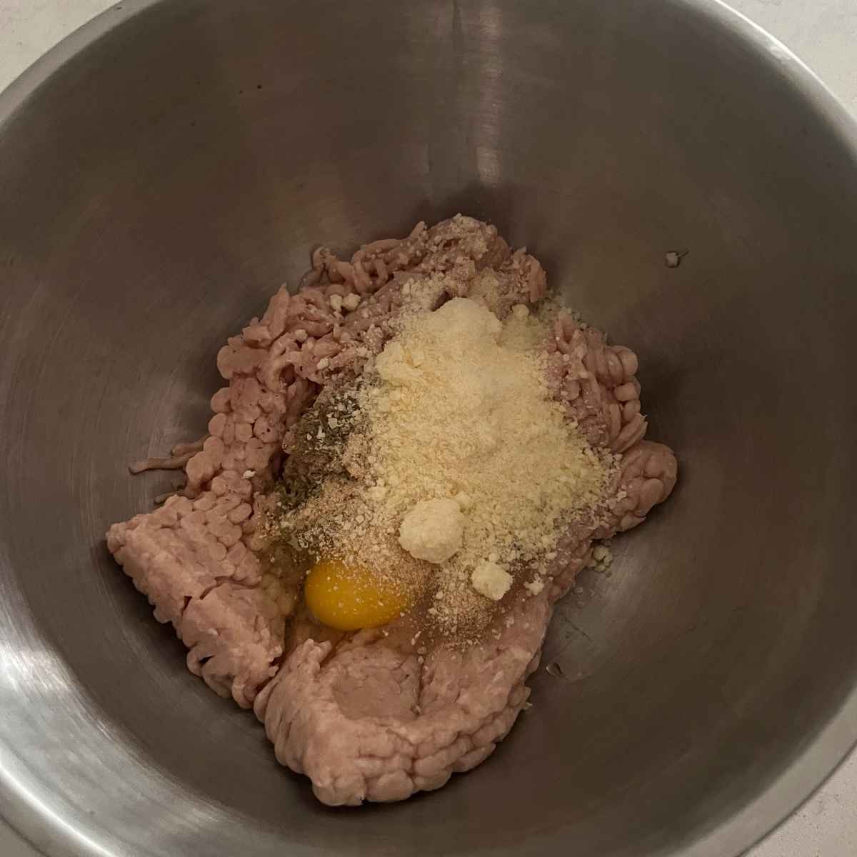 Chicken meatball mixture in a pan.