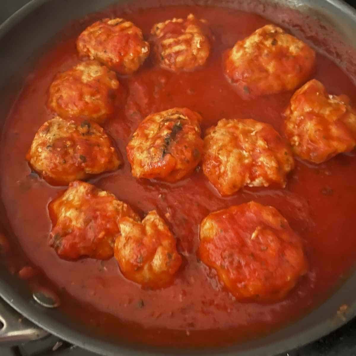 Chicken meatballs in marinara sauce.