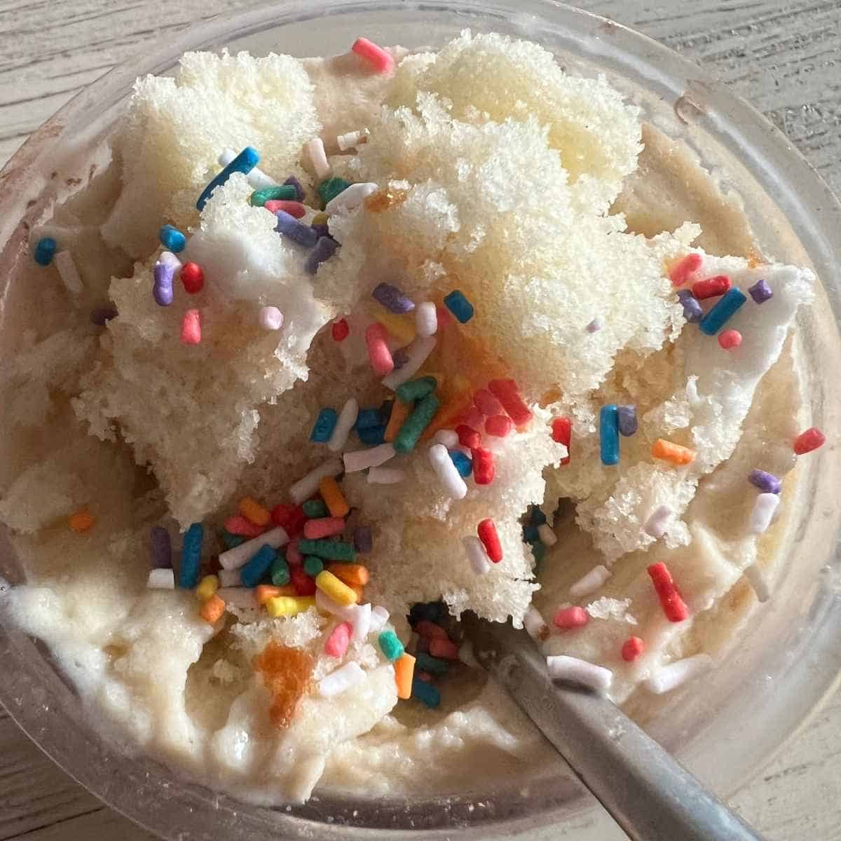 Ninja creami banana icecream topped with sprinkles and cake.
