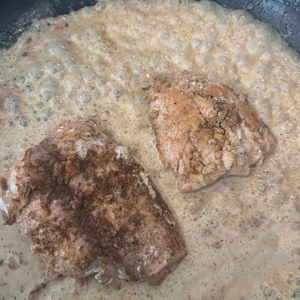Creamy cajun salmon sauce in skillet. 