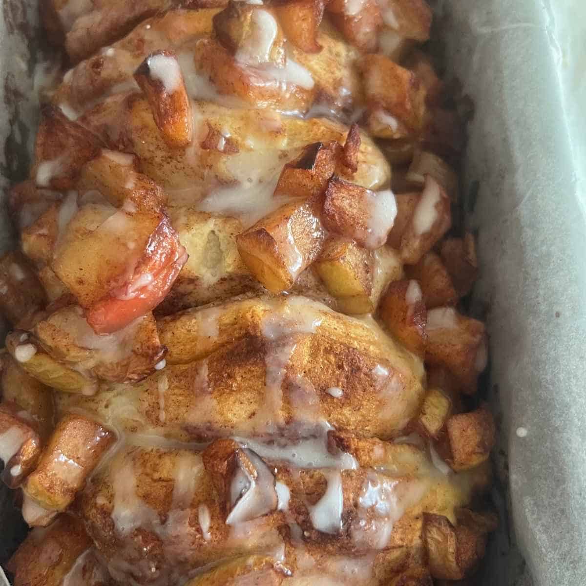 Apple pie pull apart bread topped with cooked apples.