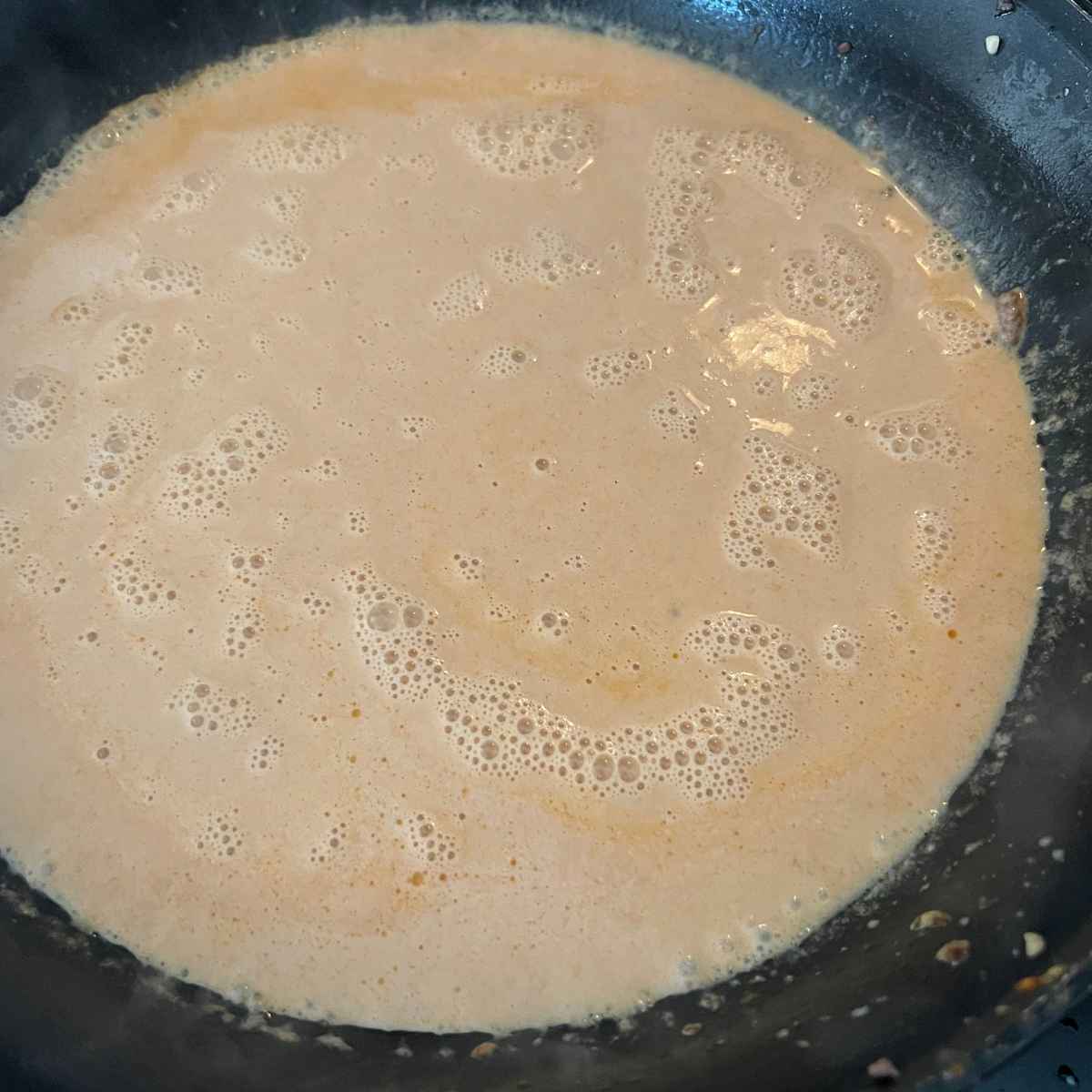 Curry sauce simmering in a pan.